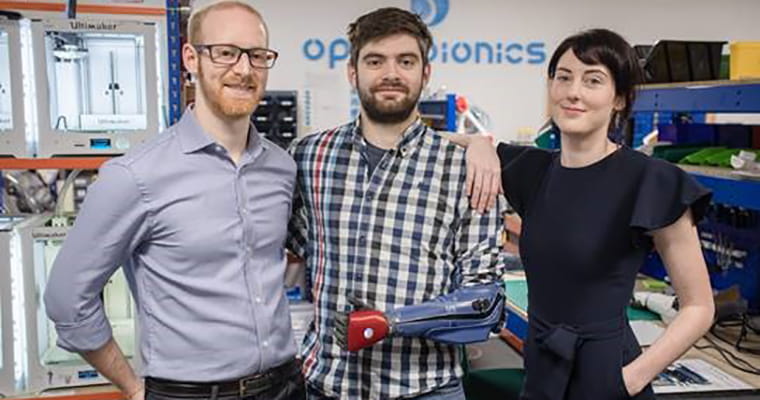 Samantha Payne and Joel Gibbard standing with man wearing bionic arm.