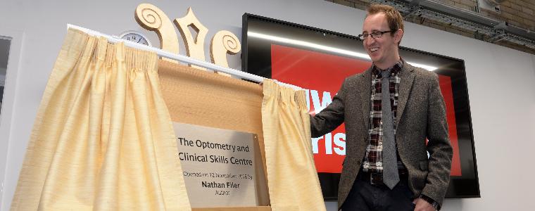 Author Nathan Filer unveiling a plaque at the opening of the optometry and clinical skills centre at UWE Bristol Glenside Campus.