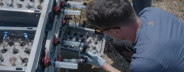 Scientist inspecting a drawer of a pee power unit.