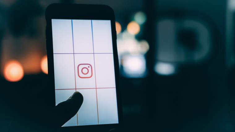 A mobile phone screen with the Instagram icon central.