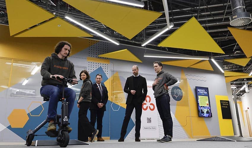 The Prince of Wales watches a demonstration of Supersmith’s 3Scooter, a three-wheeled scooter using unique self-stabilising robotic technology.