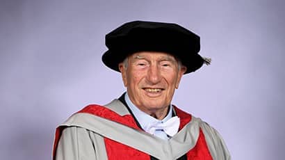Robert Channon, wearing a black cap and red graduation ceremony robes