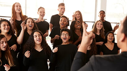 A choir, dressed in black, singing