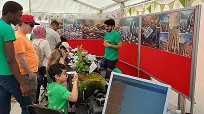 Children taking part in a public engagement event about research into how soil carbon could be monitored using sensors and acoustics