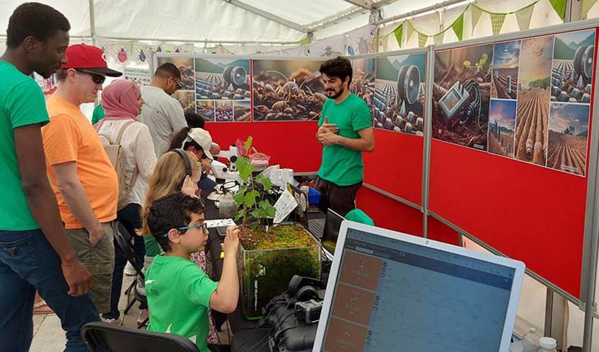 Children taking part in a public engagement event about research into how soil carbon could be monitored using sensors and acoustics
