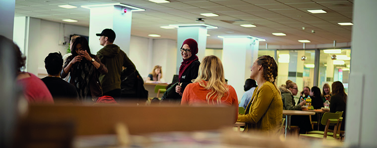Students chatting in a cafeteria.