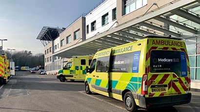 Several ambulances parked outside of a hospital
