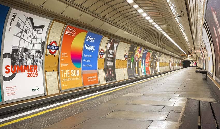 Colourful advertising facing the platform at a tube station in London