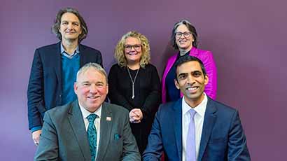 Group photo of five people with a purple background, Back: Paul Smith (Chief Revenue Officer, Skilled Education), Jo Midgley (Registrar & Deputy Vice-Chancellor, UWE Bristol), Joanne Roxburgh (Chief Operating Officer, Skilled Education); Front: Professor Sir Steve West (Vice-Chancellor and President, UWE Bristol), Rajay Naik (Chief Executive Officer, Skilled Education).