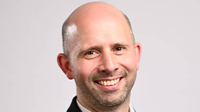 A man smiles at the camera