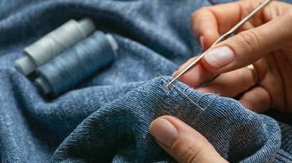 Blue fabric is given a new lease of life with a stitched repair