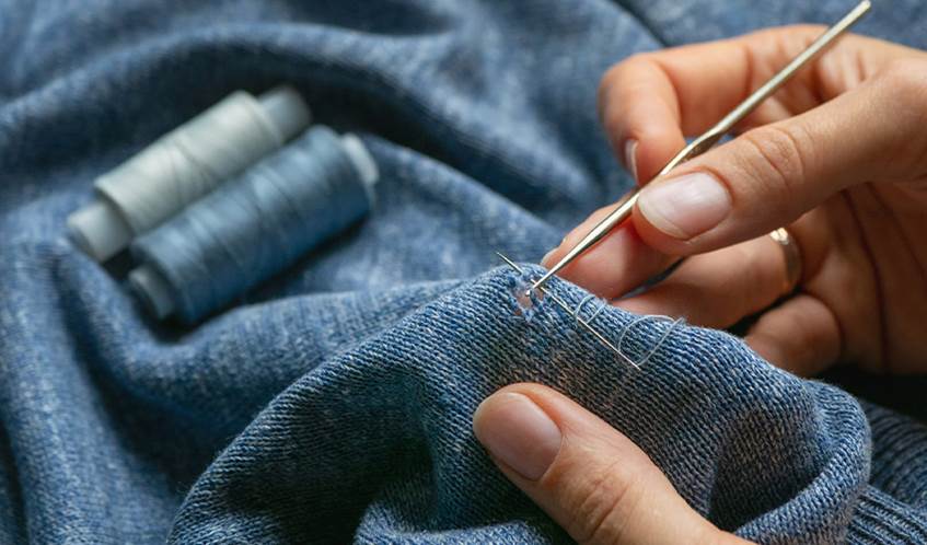 Blue fabric is given a new lease of life with a stitched repair