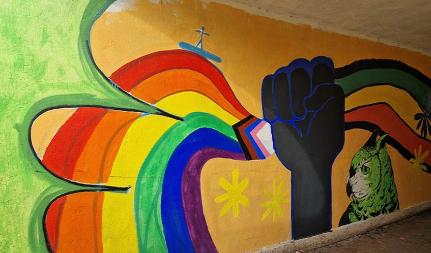 A brightly coloured mural on an underpass wall.