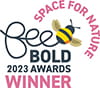 Be Bold Awards 2023 winner text in black and pink on logo with a bee illustration.