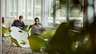 student sat using her phone handsfree