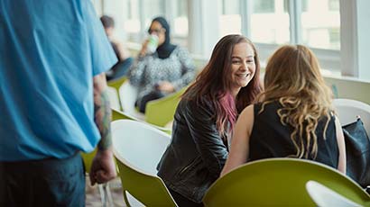 Two students chatting at a table