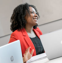 A smiling woman sat at a desk