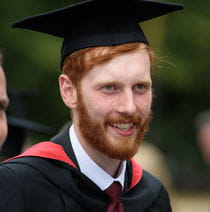 A graduating student wearing a graduation gown and cap