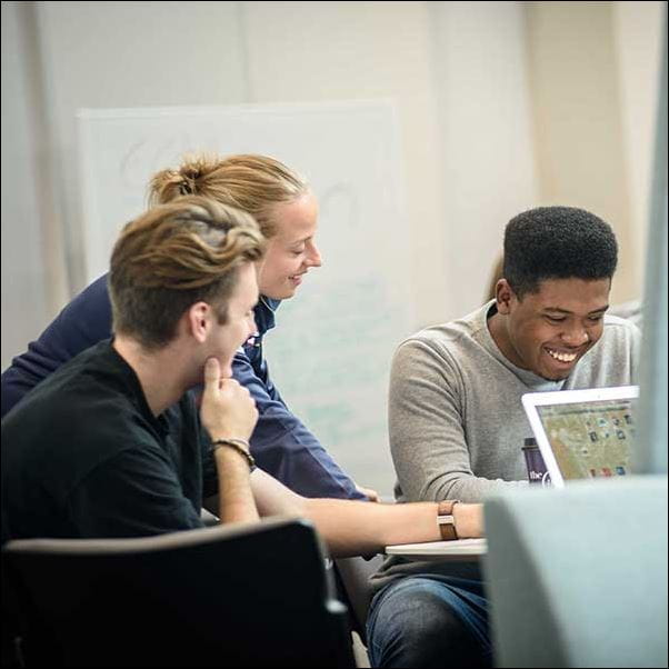 Students working together in a booth