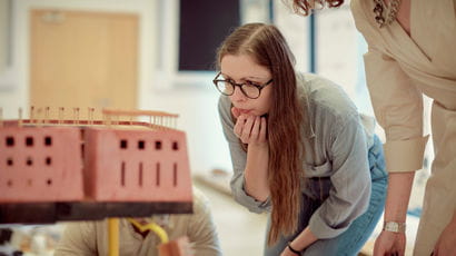 Student inspects a model of a building