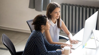 Business women look at a computer