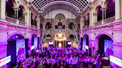 An event held in the atrium of the Bristol Museum & Art Gallery with delegates seated at tables.