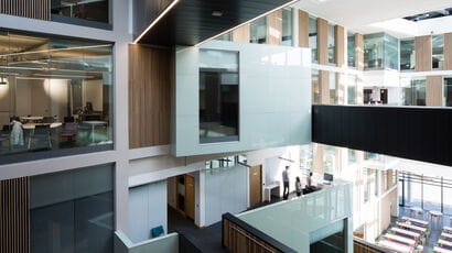 Interior of the Bristol Business School building showing the walkways and the refectory area.