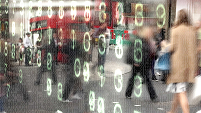 Busy city street scene with overlapping numbers of ones and zeros overlaid with glowing computer numbers. 
