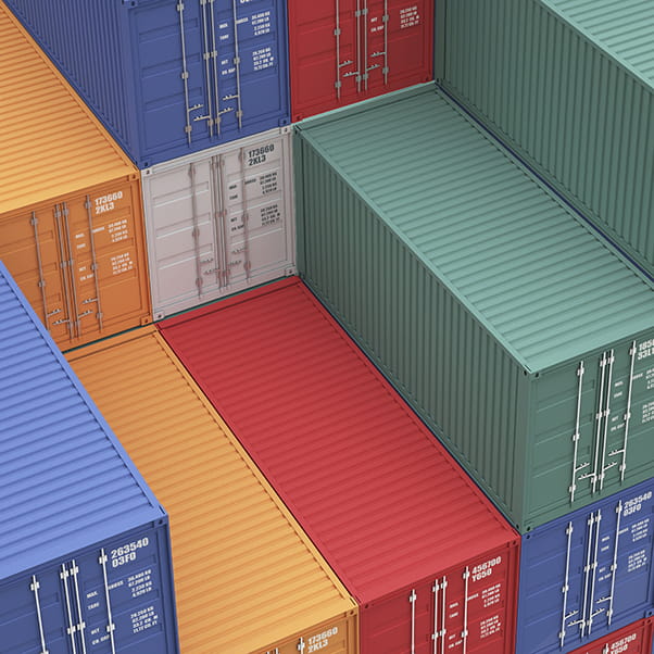 Multi-coloured shipping containers of blue, orange, green and white piled on top of each other.