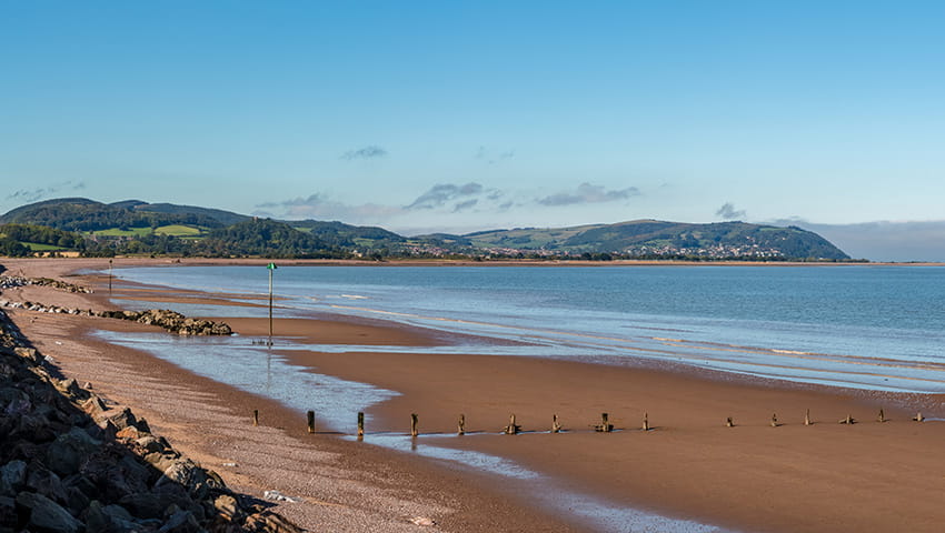 The beach in Blue Anchor, Somerset, UK with a view of the Bristol channel in the background.