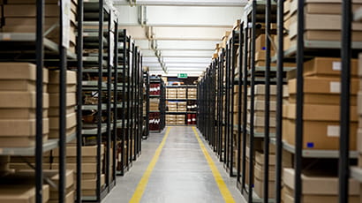 Photograph of the storage room at the records office with black shelving and yellow-coloured coded walkways.