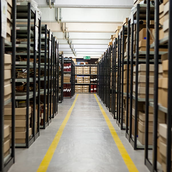 Photograph of the storage room at the records office with black shelving and yellow-coloured coded walkways.