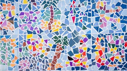 Colorful abstract ceramic mosaic with fragments of blue, white, green, brown, purple, pink, orange and black colours.