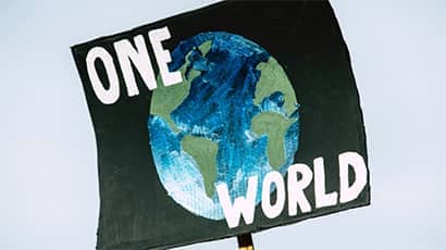 The Earth against a navy blue background with the words 'One World' in white.