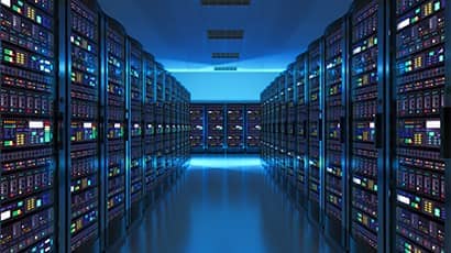 Data centre full of rack servers and super computers with lights.