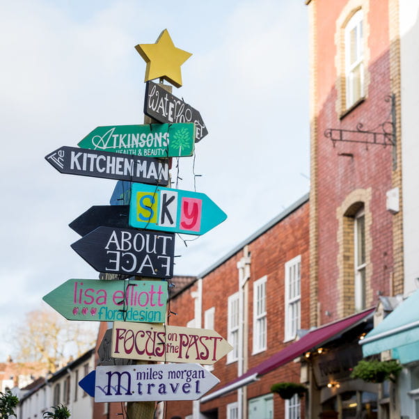 Image of a colourful multi-sign post pointing in different directions in Bristol.