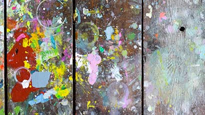 Wooden boards covered in paint creating random and abstract artistic patterns and shapes for creative background