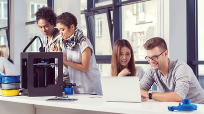 People using computers and a 3D printer