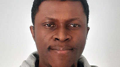 Close up headshot of FET PhD student, Jeremiah Jeremiah, against a neutral background.