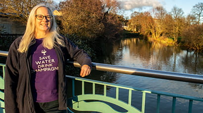 Image of UWE Bristol PhD student, Karen Simpson, standing by a river.