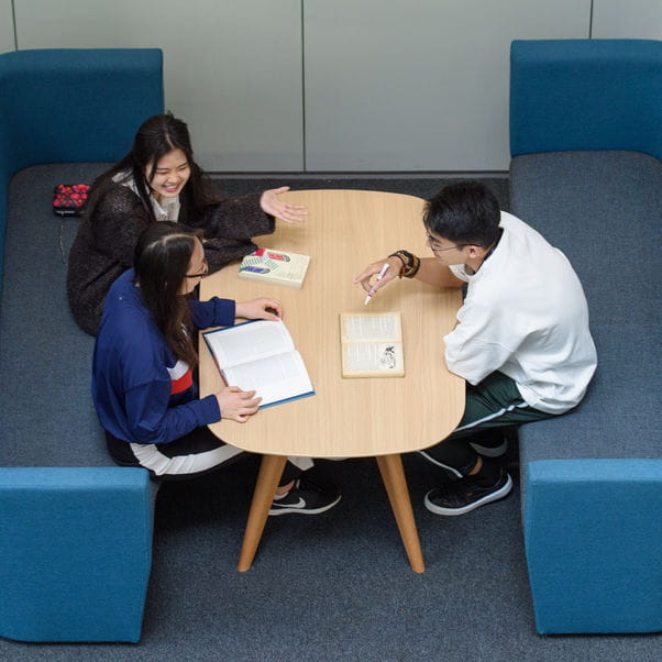 Group of students working at a table.