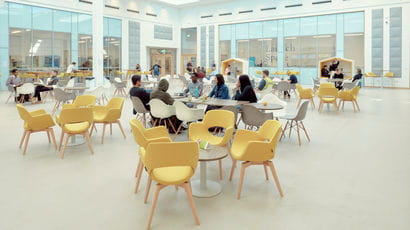 People sitting at tables in the Enterprise Zone.