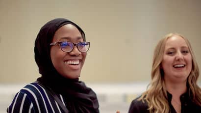 Students smiling in a study room.