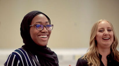 Students smiling in a study room.