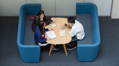 Group of smartly dressed people sitting at a table.