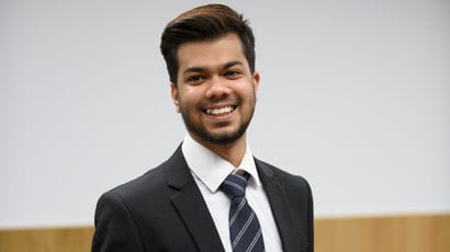 Smartly dressed student standing in a law court.