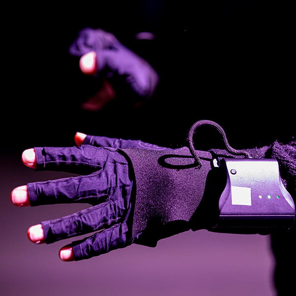A close up of a hand wearing a virtual reality glove