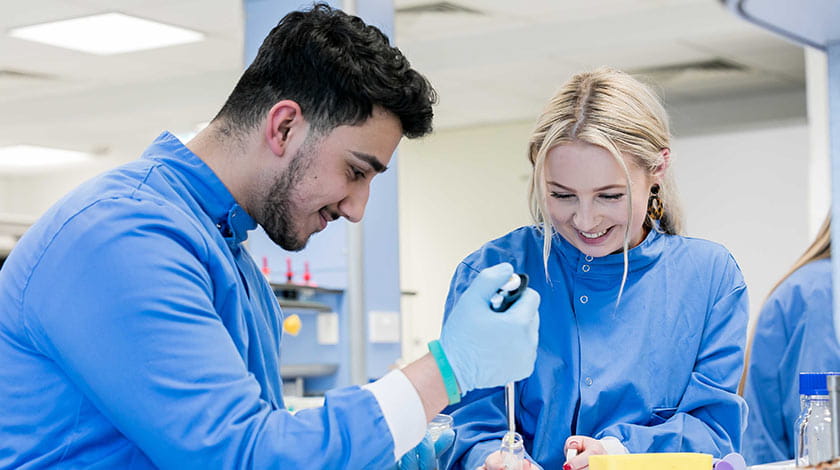 Two students working in a lab.