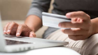 Person paying fees with credit card online.