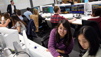 Students working on computers in a study room.